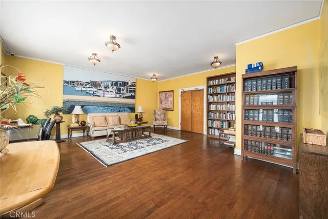 a living room with furniture and a book shelf