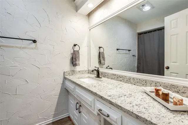 a bedroom with a bed and a potted plant