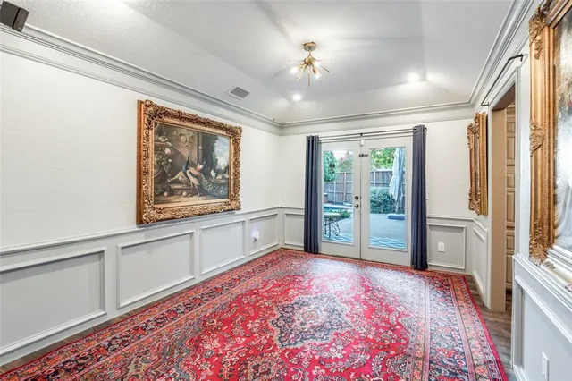 a view of a hallway with wooden floor and chandelier