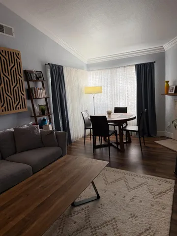 a bathroom with a granite countertop sink a toilet a mirror and shower