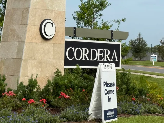 a sign broad in front of flowers