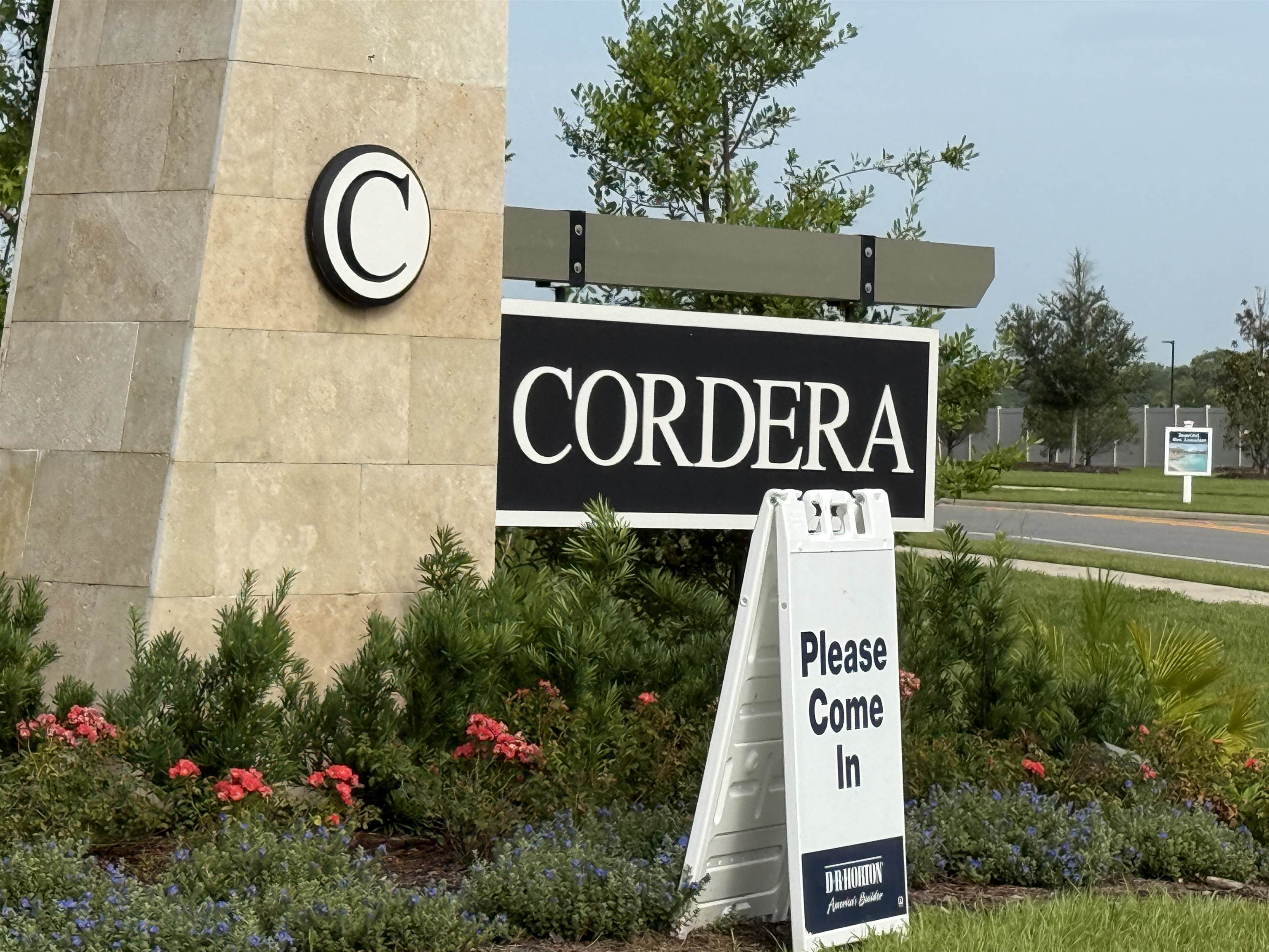 a sign broad in front of flowers