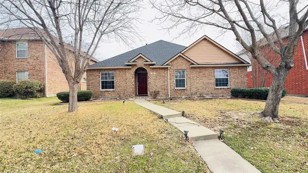 a house that has a tree in front of it