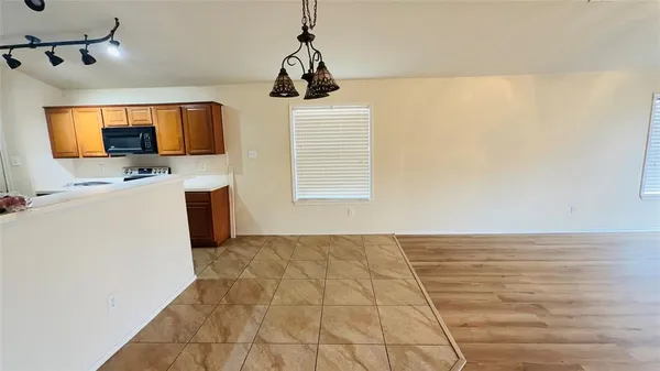 a view of a room with a flat screen tv and kitchen view