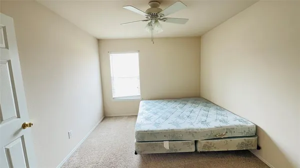 a bedroom with a bed and window