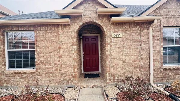 a view of front door of a house with large windows