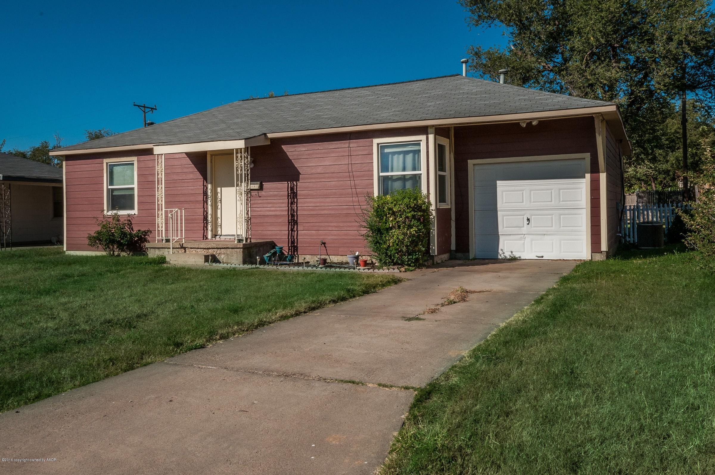 4402 Parker Street Amarillo, TX 79110 - Photo 1 of 21 a front view of a house with a yard and trees