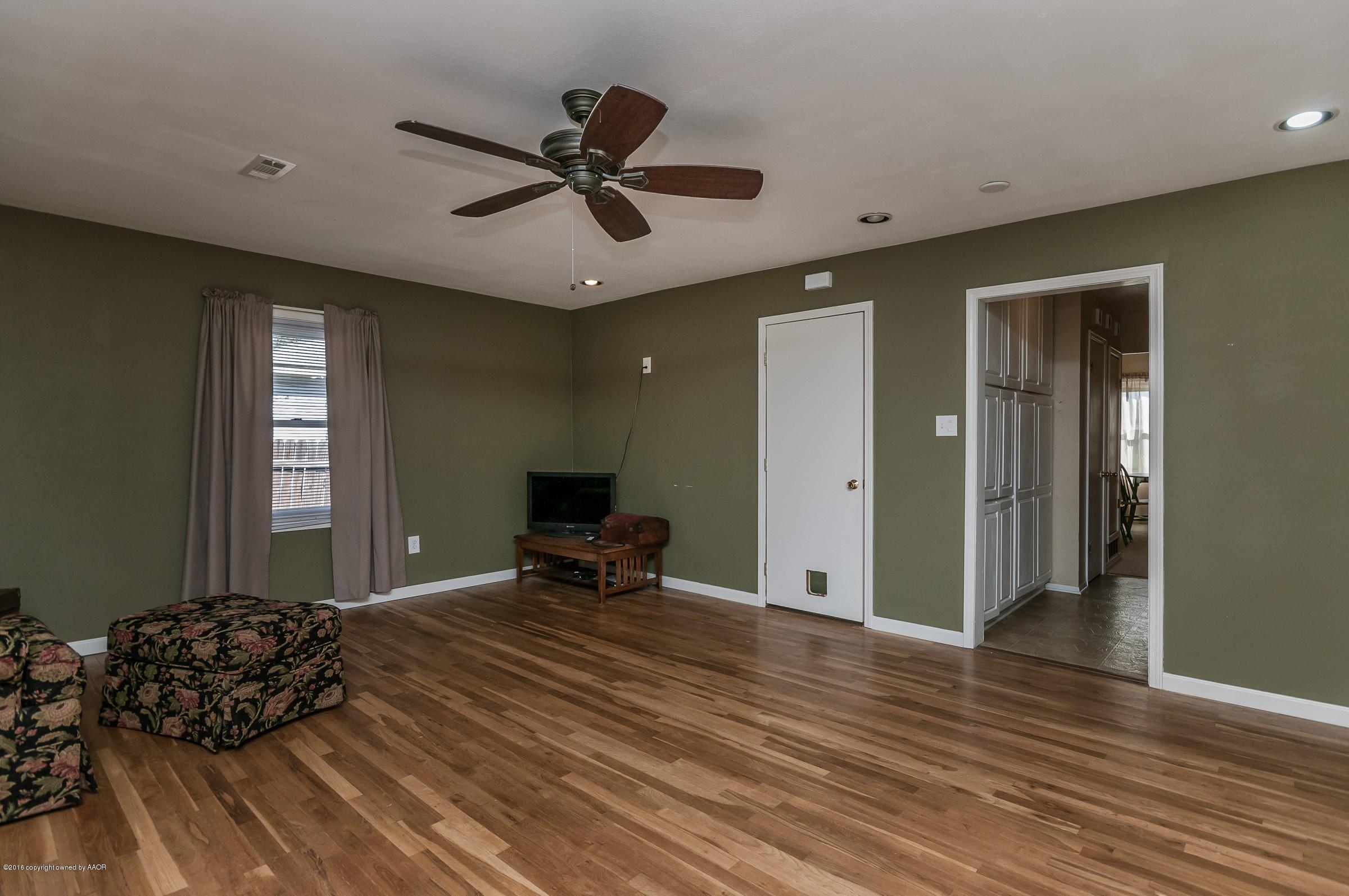 4402 Parker Street Amarillo, TX 79110 - Photo 12 of 21 a bedroom with a bed and wooden floor