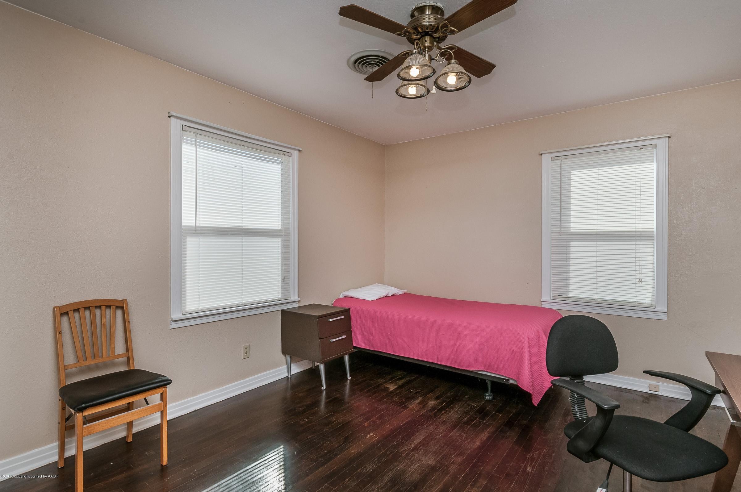 4402 Parker Street Amarillo, TX 79110 - Photo 17 of 21 a bedroom with a bed and a window