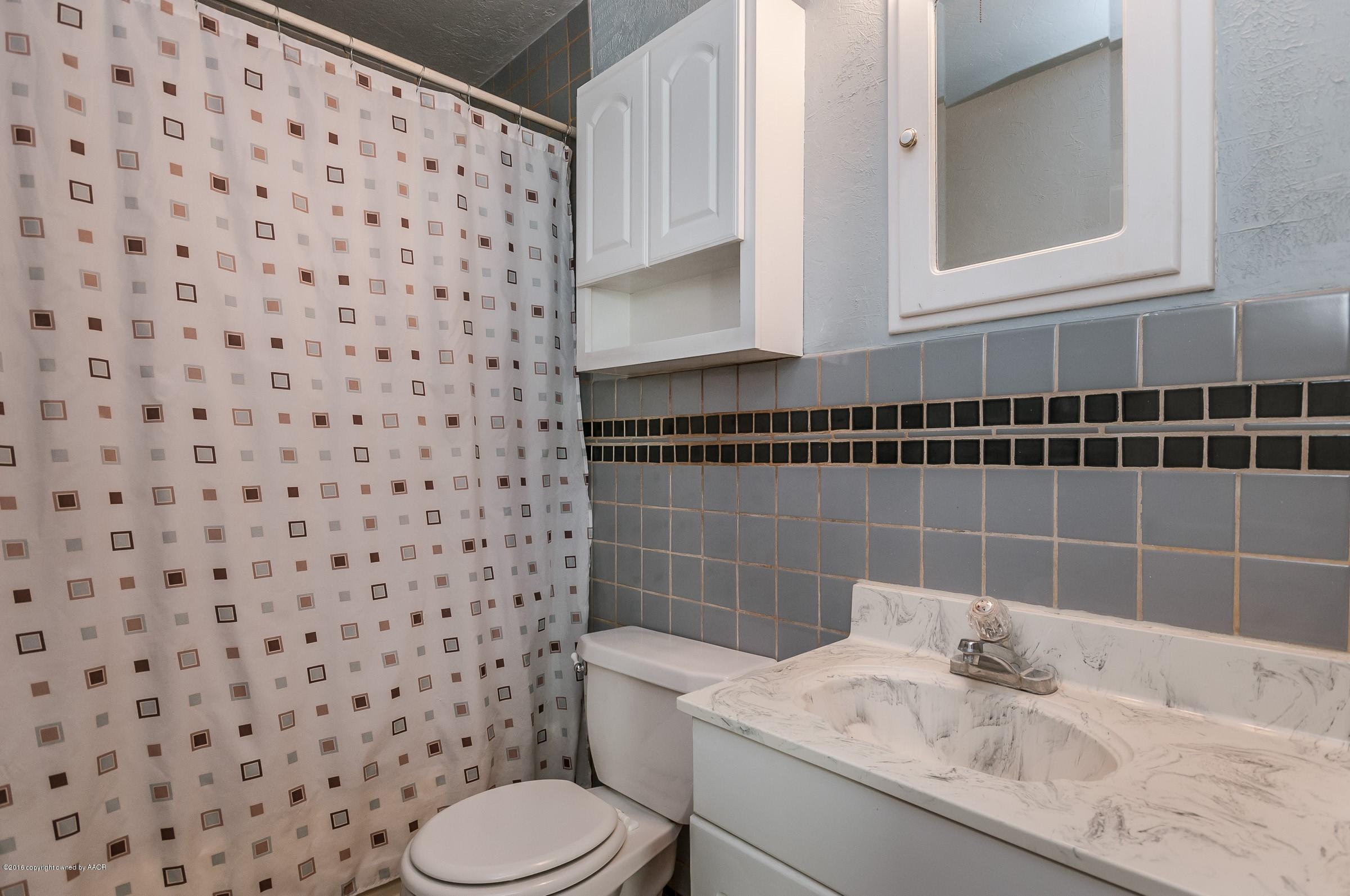 4402 Parker Street Amarillo, TX 79110 - Photo 18 of 21 a bathroom with a sink toilet and shower