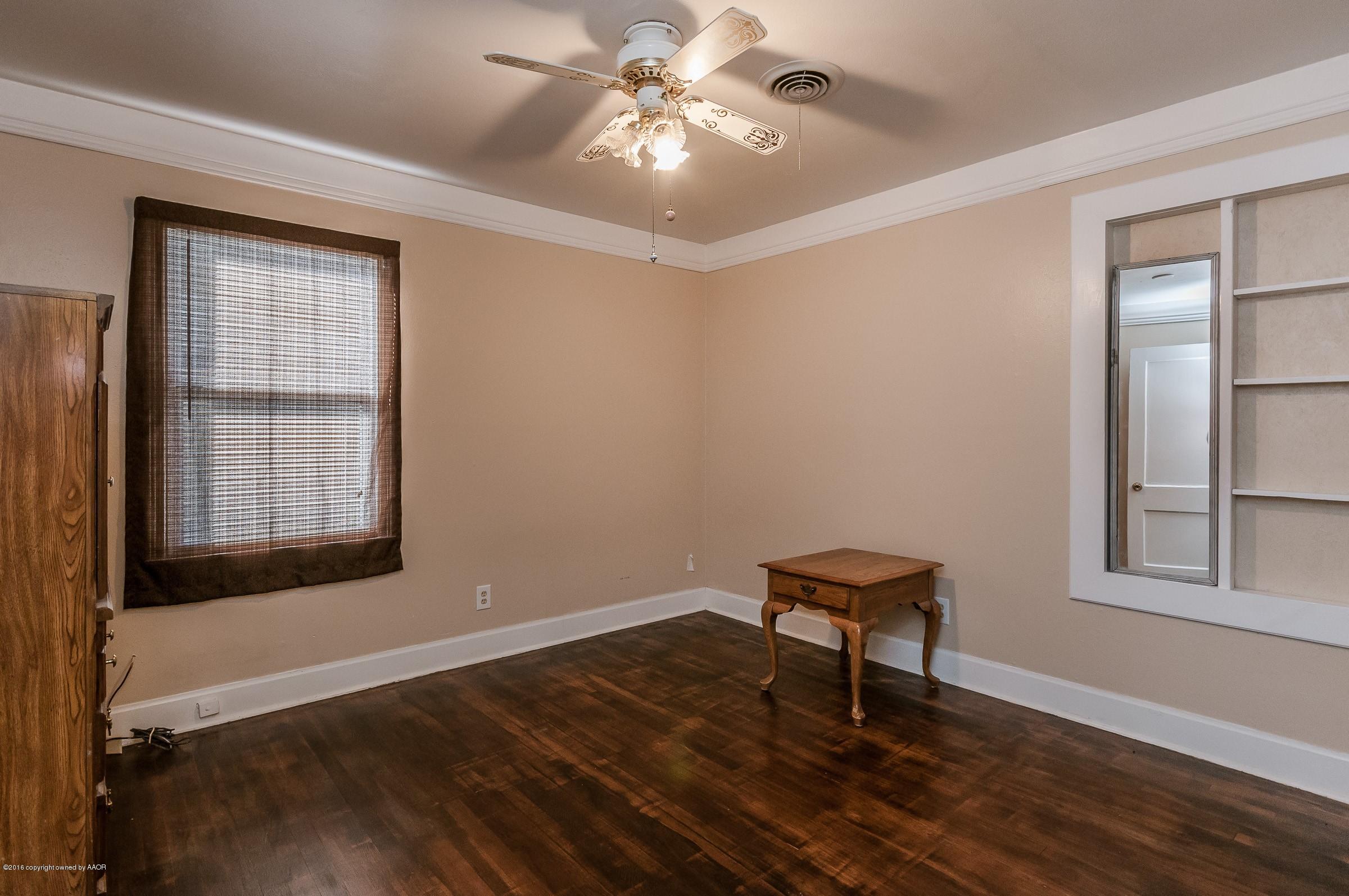 4402 Parker Street Amarillo, TX 79110 - Photo 19 of 21 a view of a room with wooden floor and windows