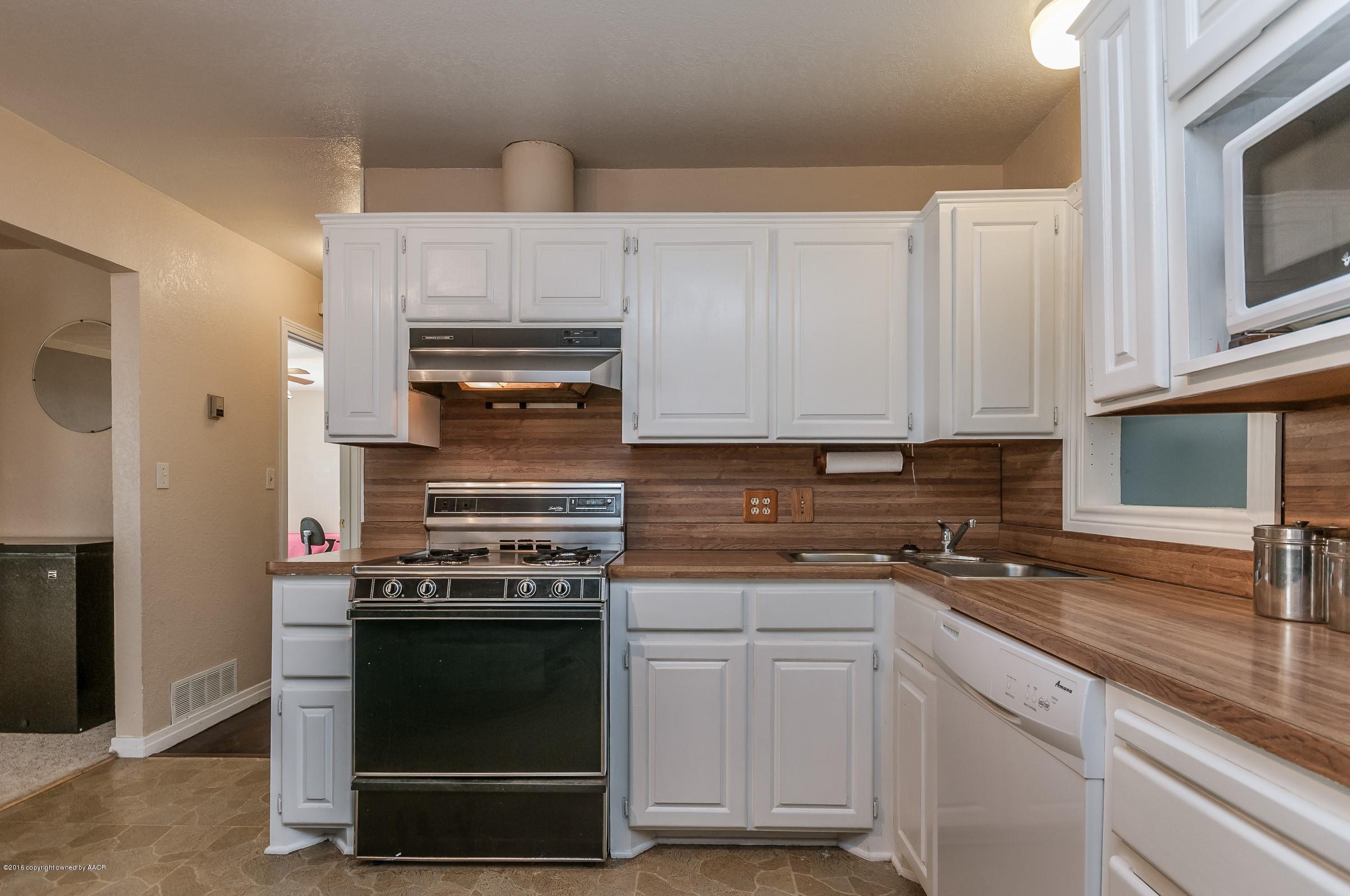4402 Parker Street Amarillo, TX 79110 - Photo 8 of 21 a kitchen with white cabinets and appliances