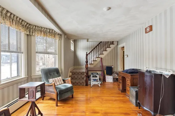 a living room with furniture and large windows