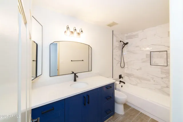 a bathroom with a double vanity sink mirror double and bathtub