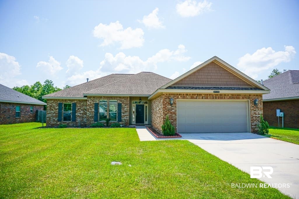 593 Begeman Road Mobile, AL 36608 - Photo 2 of 23 View of front of home featuring a garage and a front yard