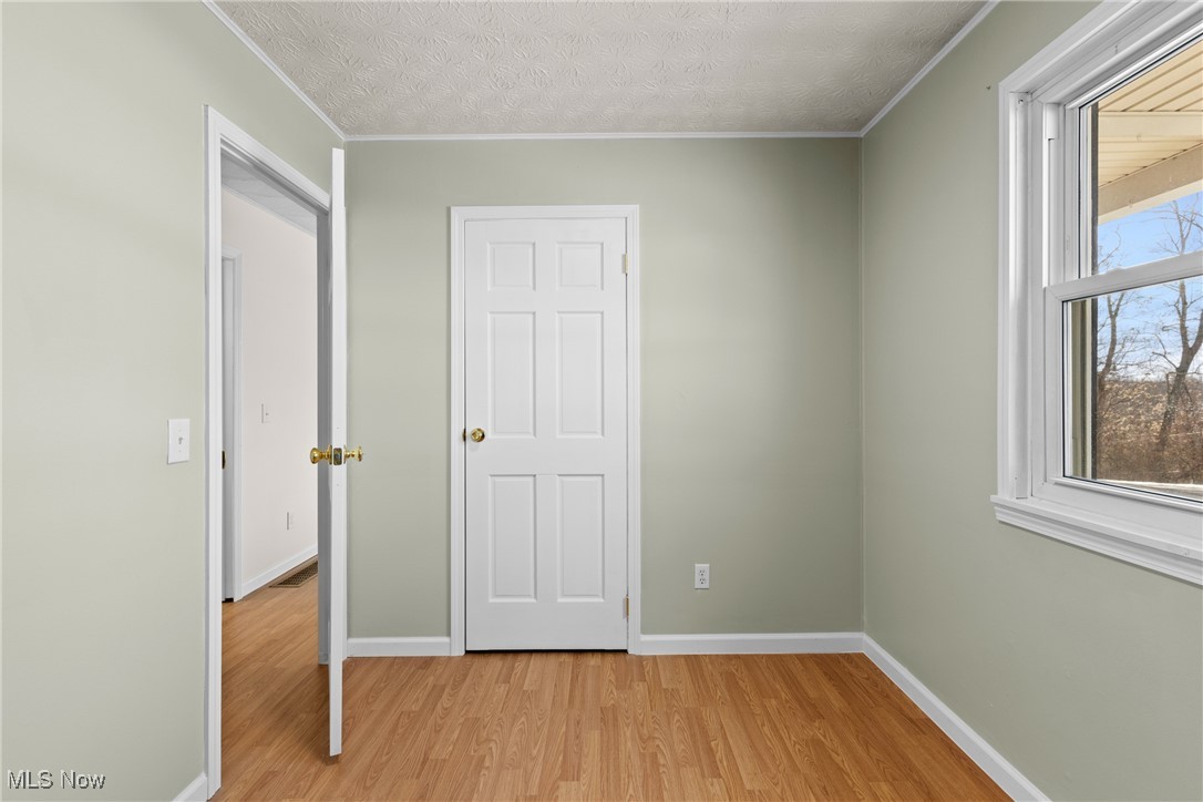 61899 Webb Heights Road Shadyside, OH 43947 - Photo 20 of 39 Unfurnished bedroom with a textured ceiling and light wood-type flooring