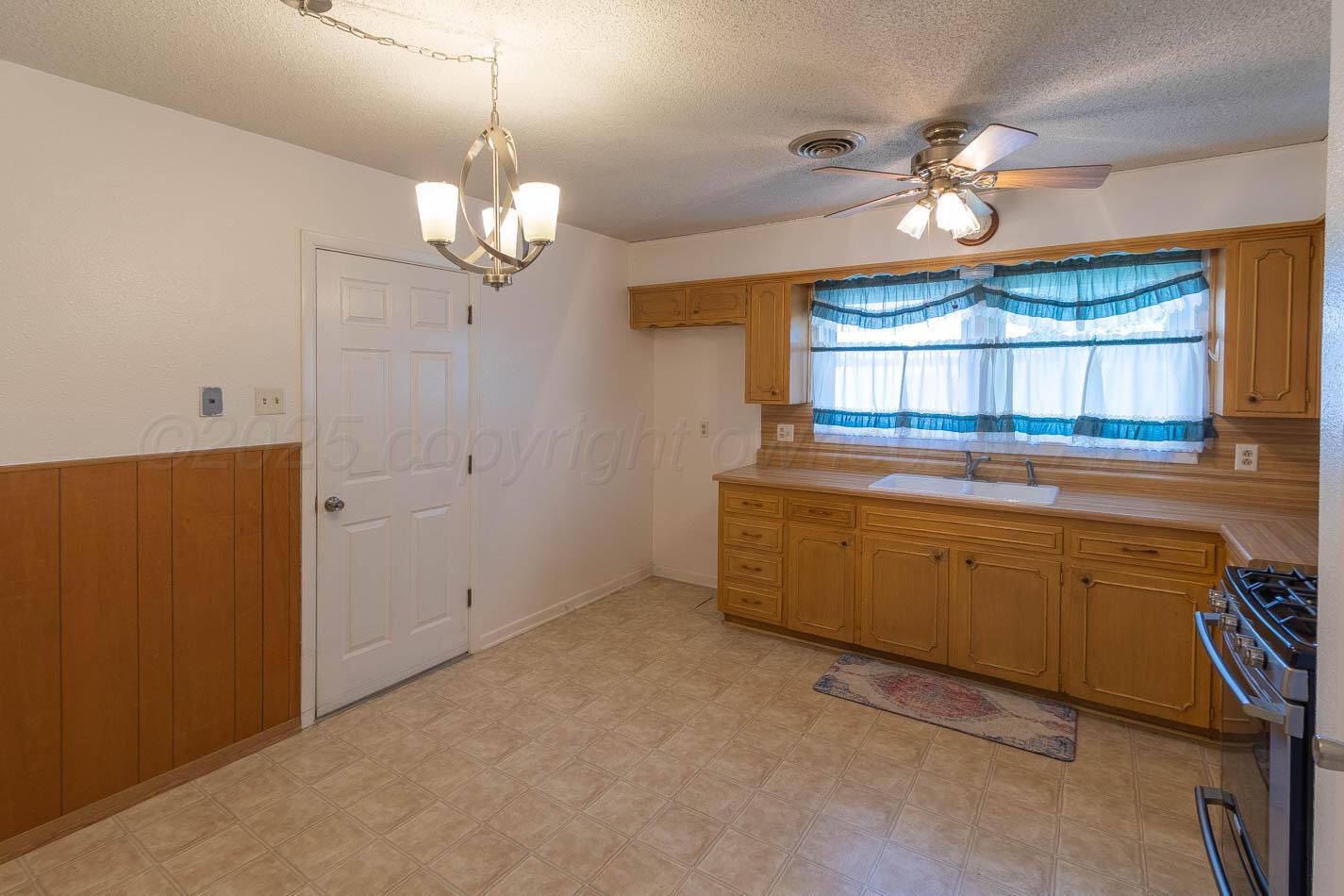 4413 Southeast 28th Avenue Amarillo, TX 79103 - Photo 5 of 13 a kitchen that has a lot of cabinets and wooden floor