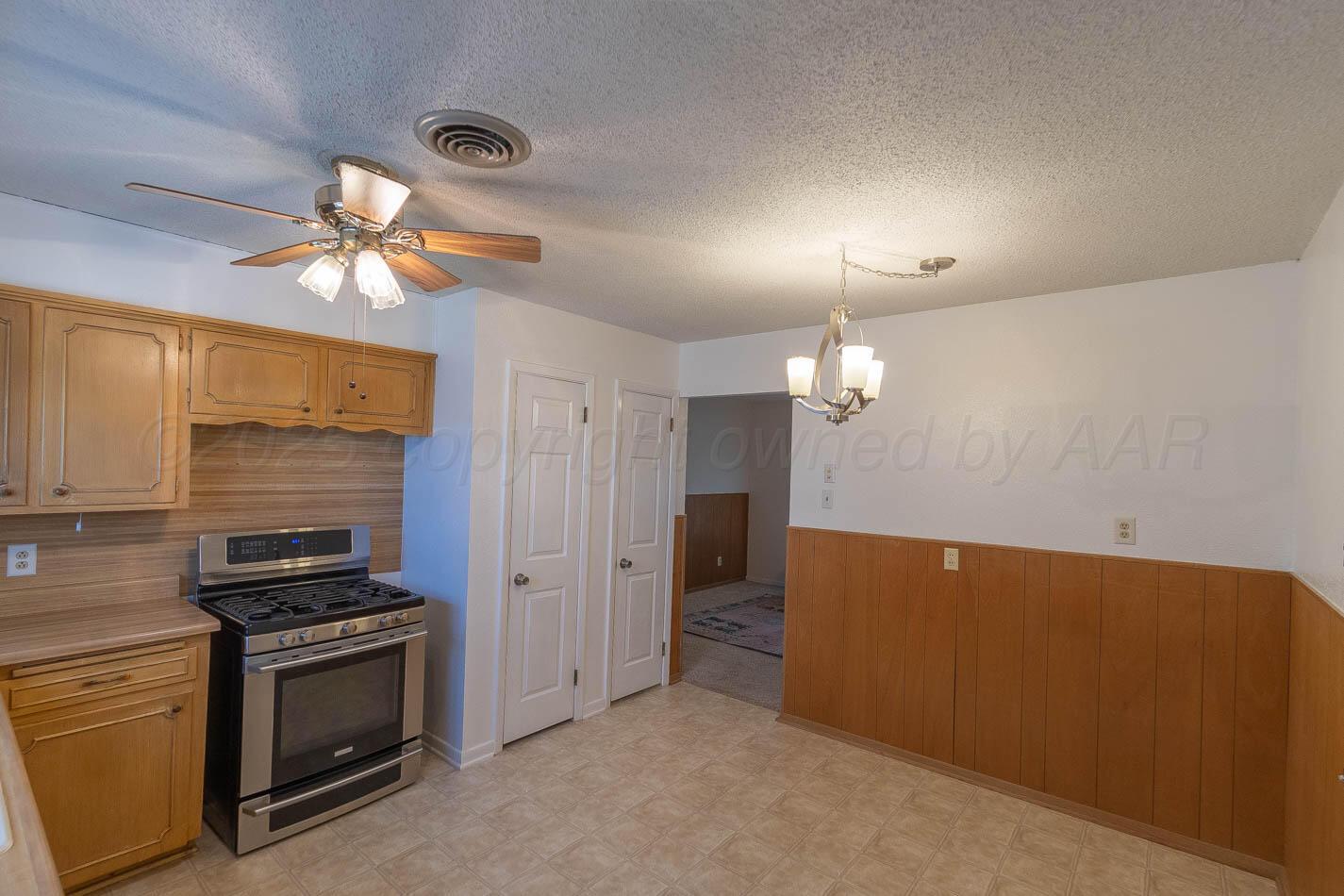 4413 Southeast 28th Avenue Amarillo, TX 79103 - Photo 6 of 13 a kitchen with cabinets and stainless steel appliances