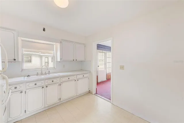 a spacious bathroom with a granite countertop sink and a mirror