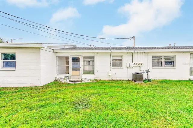 a view of a house with a yard and sitting area