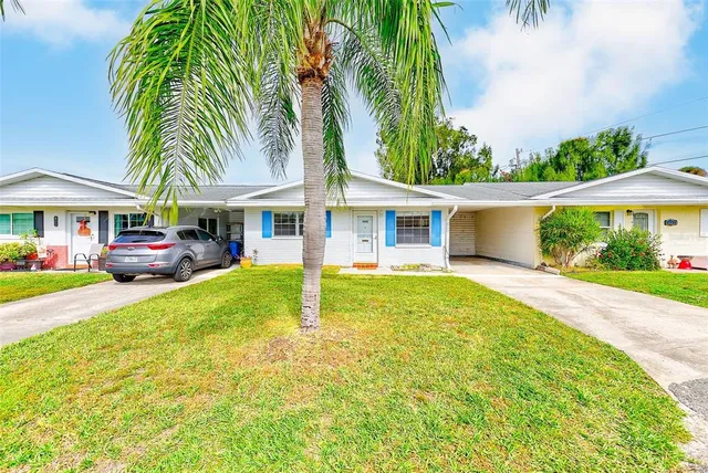 a swimming pool with outdoor seating and yard