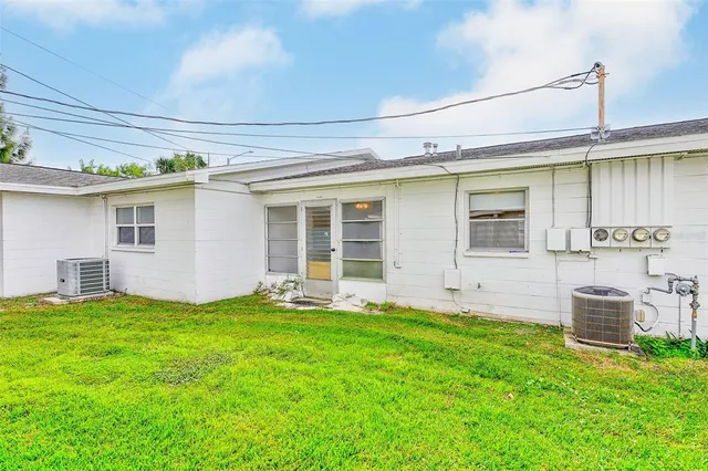 a backyard of a house with table and chairs