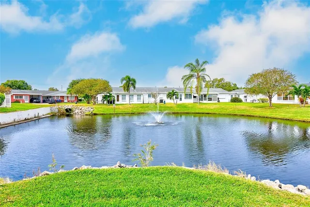 a view of a lake with houses in the back
