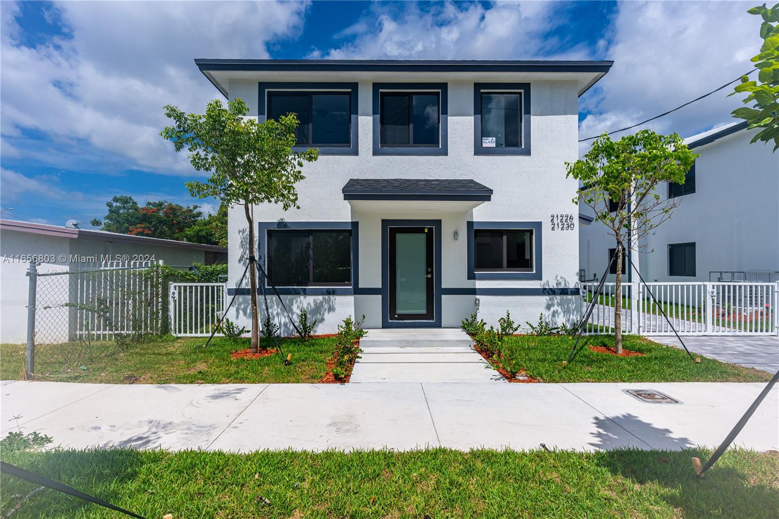 1801 Northwest 112th Street, Unit 1 Miami, FL 33167 - Photo 1 of 22 a view of house with a yard and potted plants