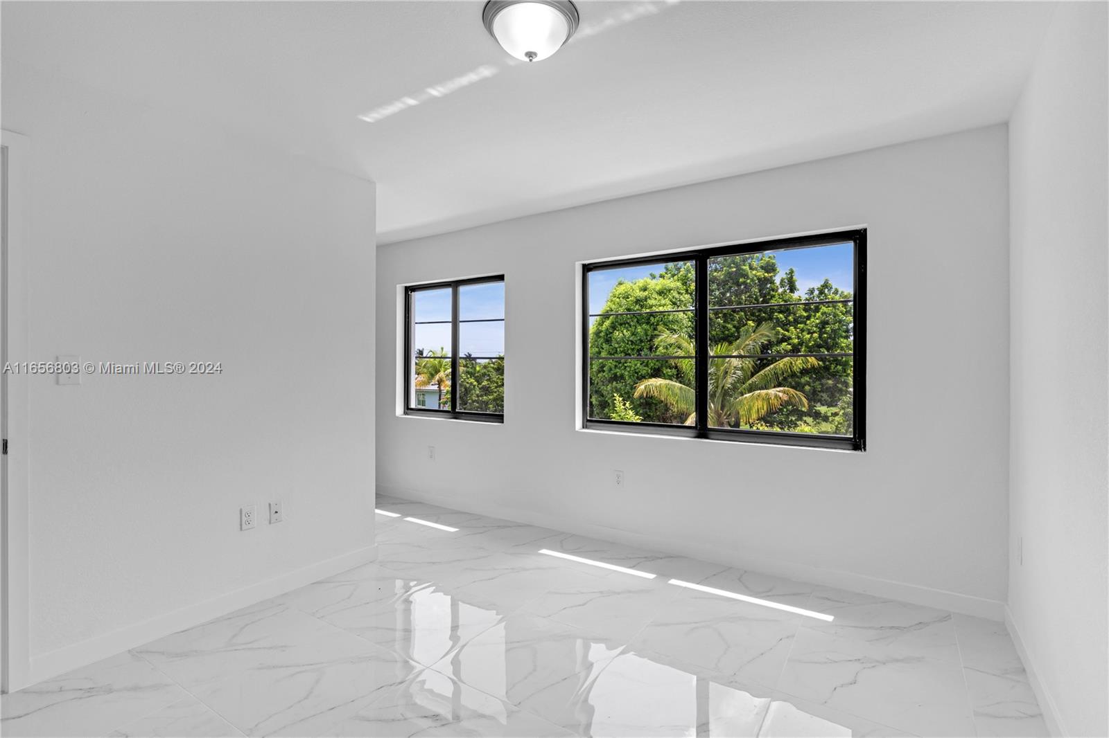 1801 Northwest 112th Street, Unit 1 Miami, FL 33167 - Photo 12 of 22 a view of an empty room with a window