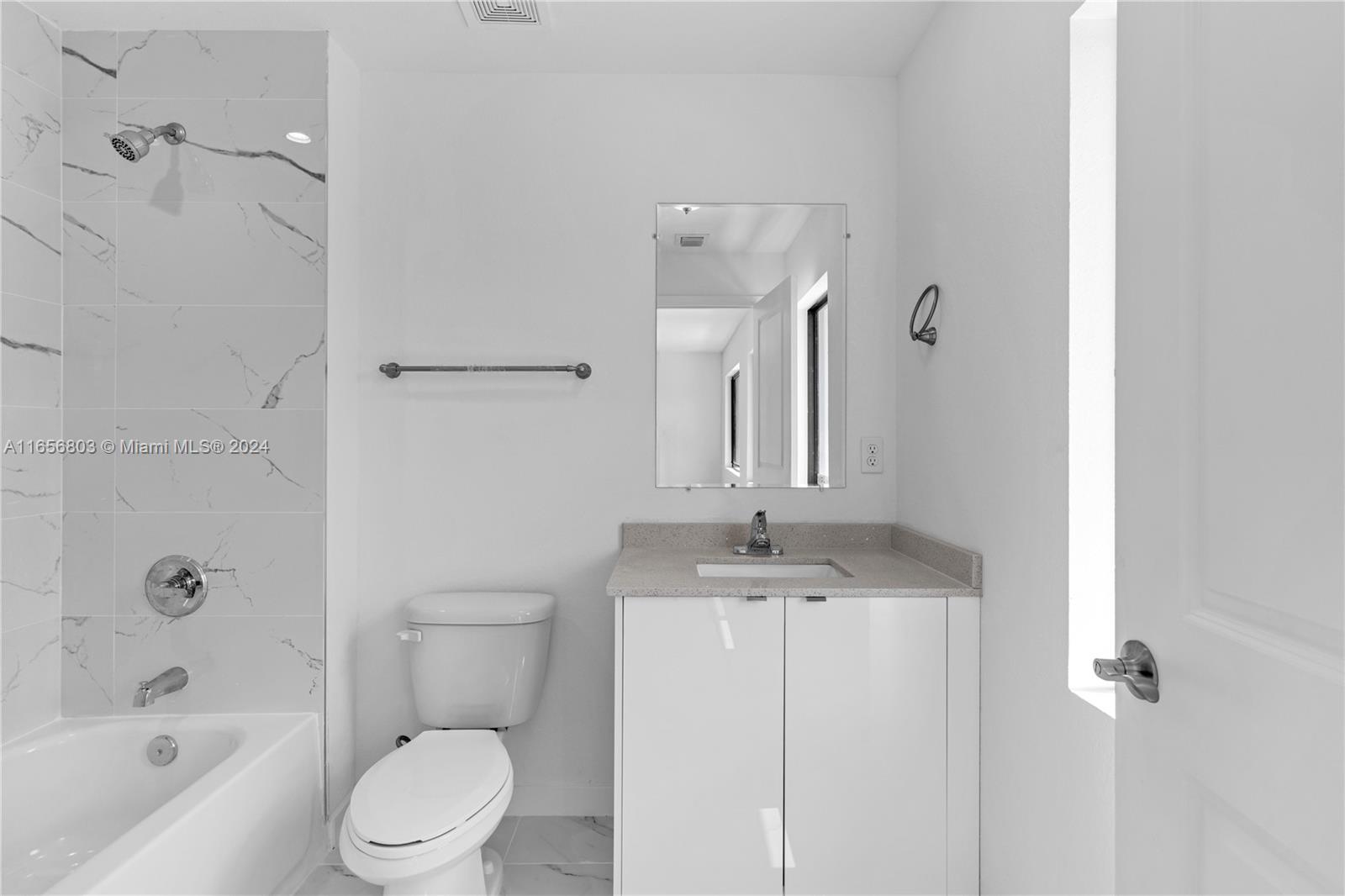 1801 Northwest 112th Street, Unit 1 Miami, FL 33167 - Photo 16 of 22 a bathroom with a granite countertop sink a toilet and shower