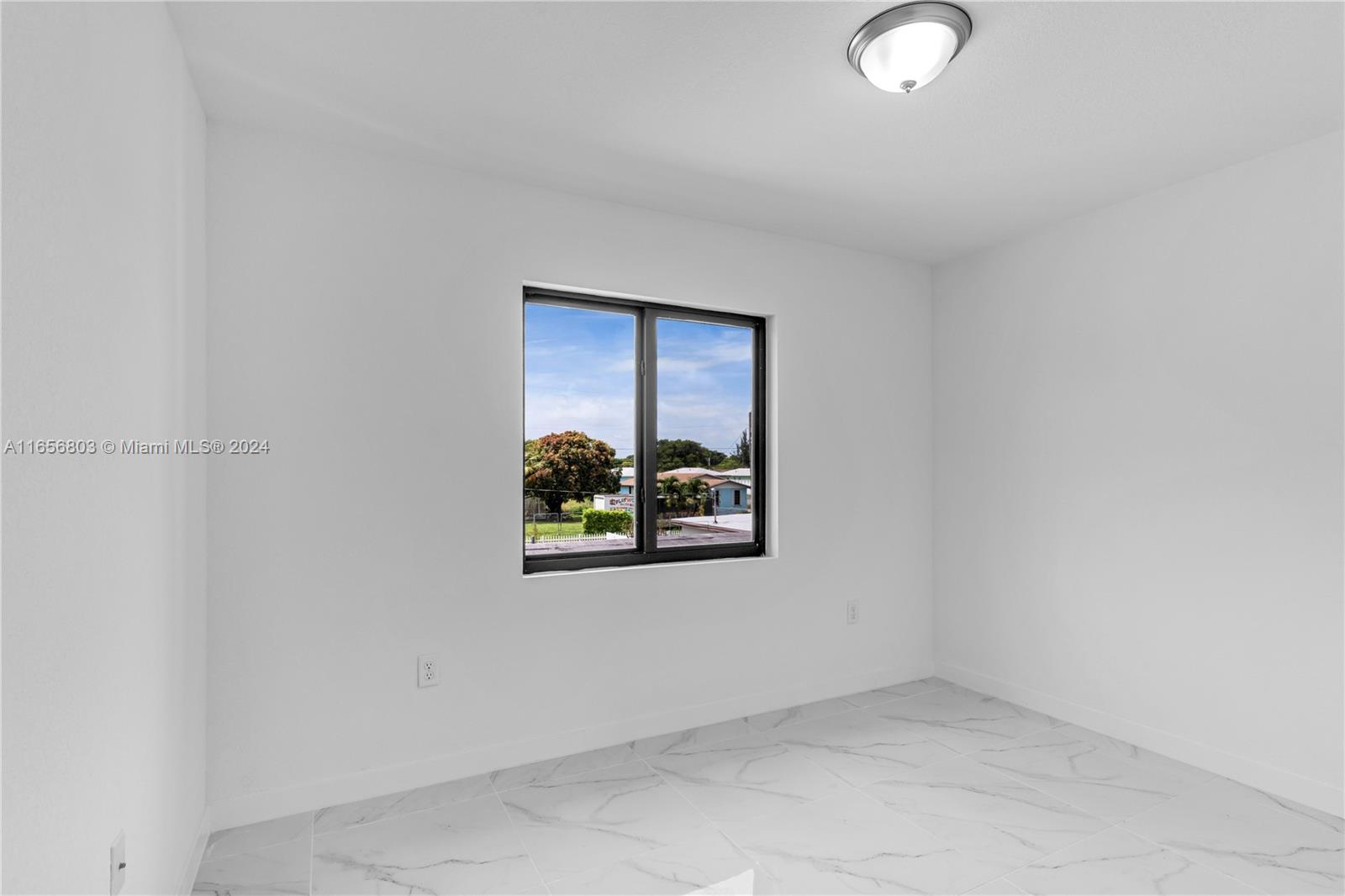 1801 Northwest 112th Street, Unit 1 Miami, FL 33167 - Photo 18 of 22 an empty room with a window