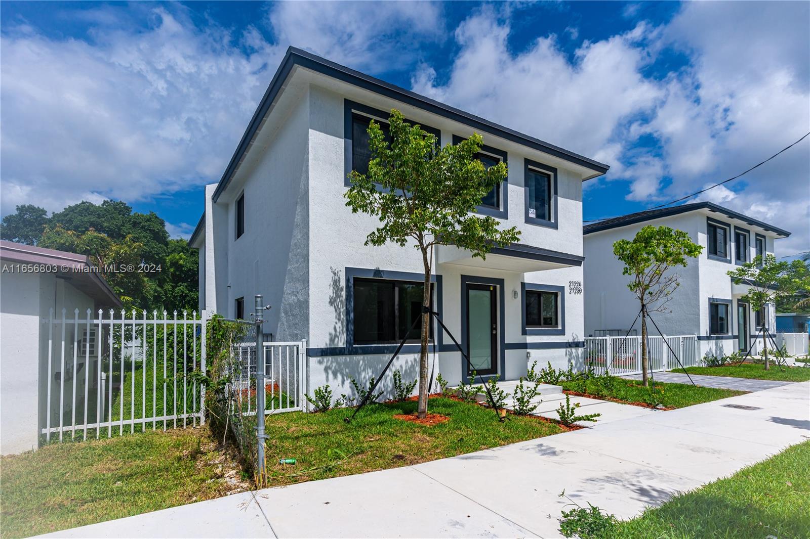 1801 Northwest 112th Street, Unit 1 Miami, FL 33167 - Photo 2 of 22 a front view of a house with a yard