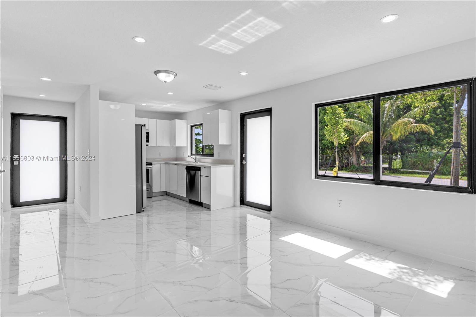 1801 Northwest 112th Street, Unit 1 Miami, FL 33167 - Photo 3 of 22 a view of a kitchen with refrigerator and windows