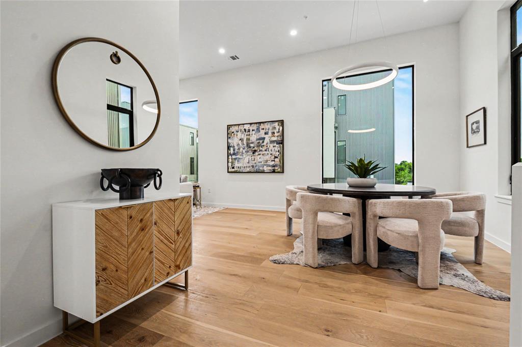1111 Raiford Road, Unit 128 Carrollton, TX 75007 - Photo 3 of 18 Open-concept living but with designated areas. Each home features tall ceilings, expansive windows, white oak hardwood floors, and designer touches throughout. (pic from unit facing same direction)