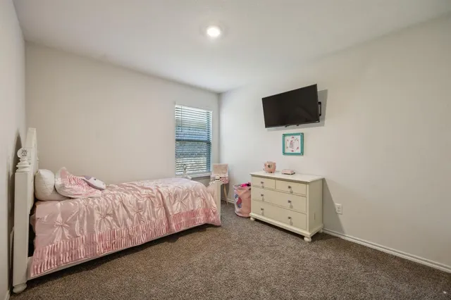 a room with a bed and a flat screen tv