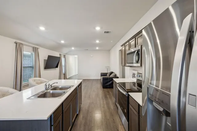 a kitchen with a sink stove and refrigerator