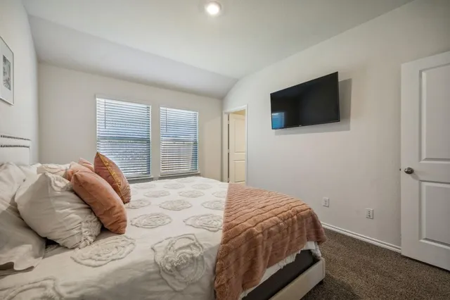 a bedroom with a bed and a television