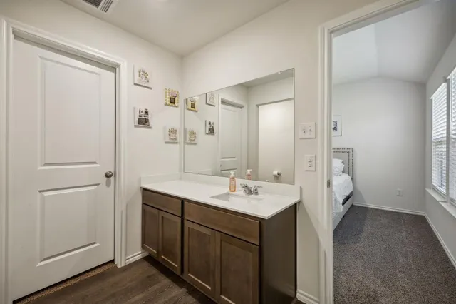 a bathroom with a sink a mirror and a shower