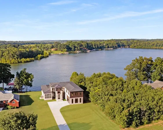 an aerial view of a house with a lake view