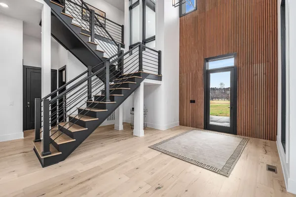 a view of an entryway with wooden floor