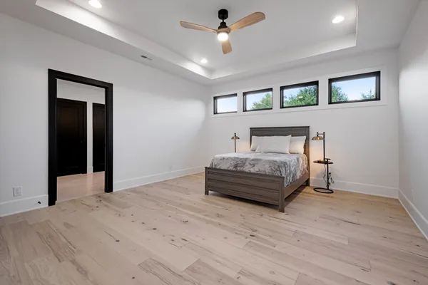 a bedroom with a bed and a chandelier