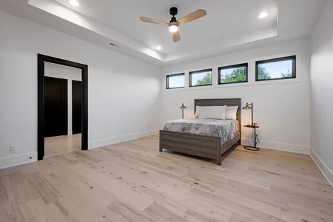 an empty room with window wooden floor and windows