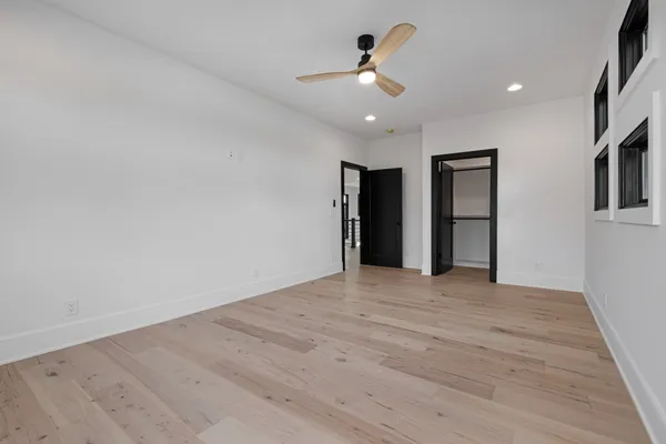 a view of an empty room with a ceiling fan