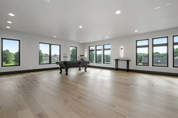 an empty room with window wooden floor and windows