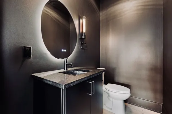 a bathroom with a toilet and a mirror