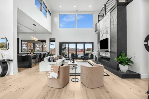 a dining room with furniture and a floor to ceiling window