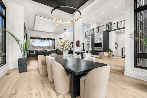 a dining room with furniture and wooden floor