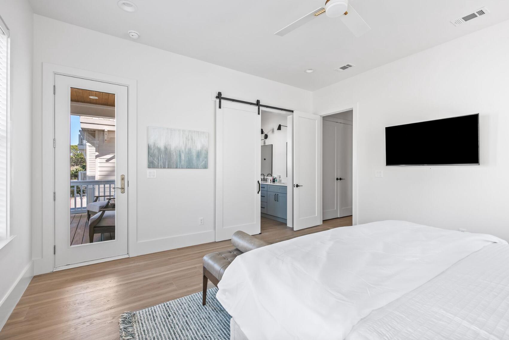 205 Redbud Ln Inlet Beach Inlet Beach, FL 32461 - Photo 12 of 34 a bedroom with a bed and a flat screen tv