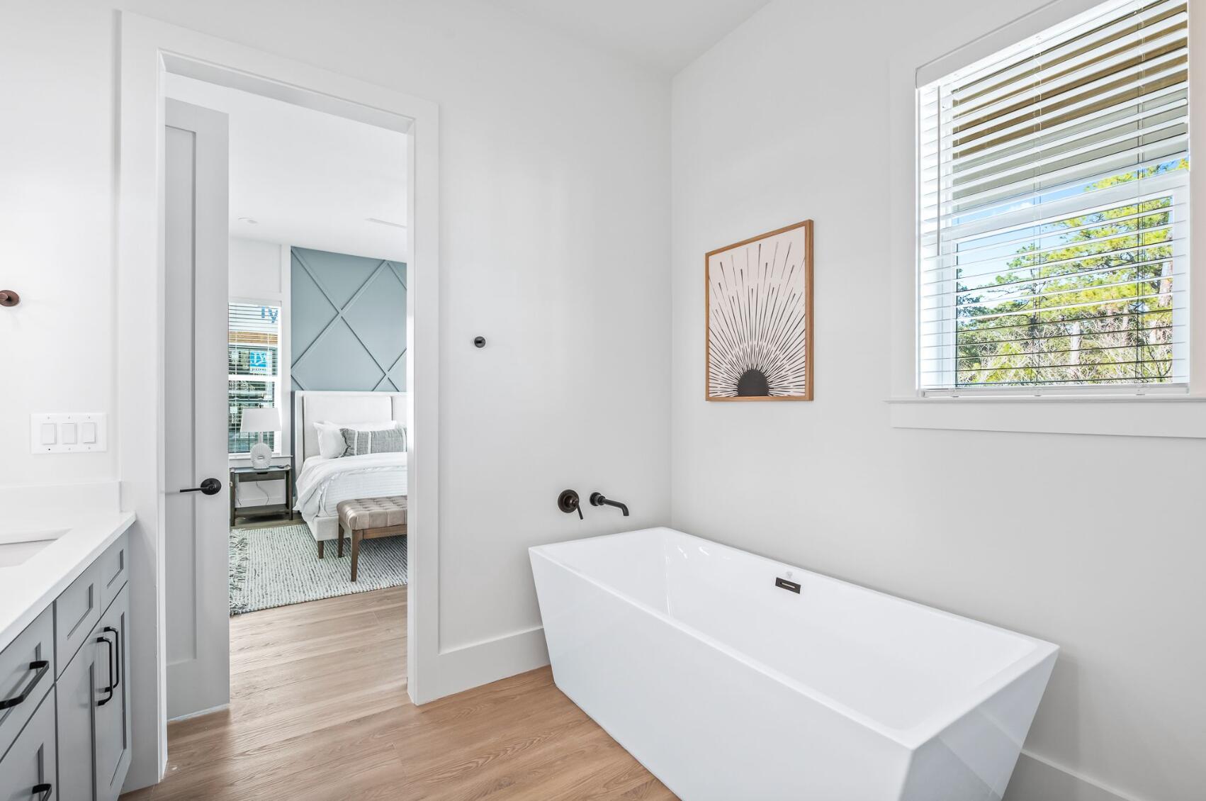 205 Redbud Ln Inlet Beach Inlet Beach, FL 32461 - Photo 15 of 34 a bathroom with a white tub sitting next to a window