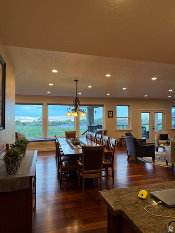 3145 South 500 West Vernal, UT 84078 - Photo 64 of 64 Dining space featuring dark wood finished floors, a chandelier, and a textured ceiling